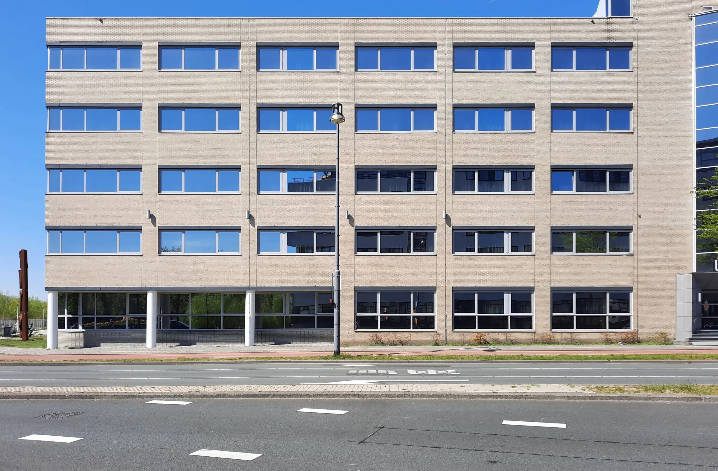 The facade of an office building on a street