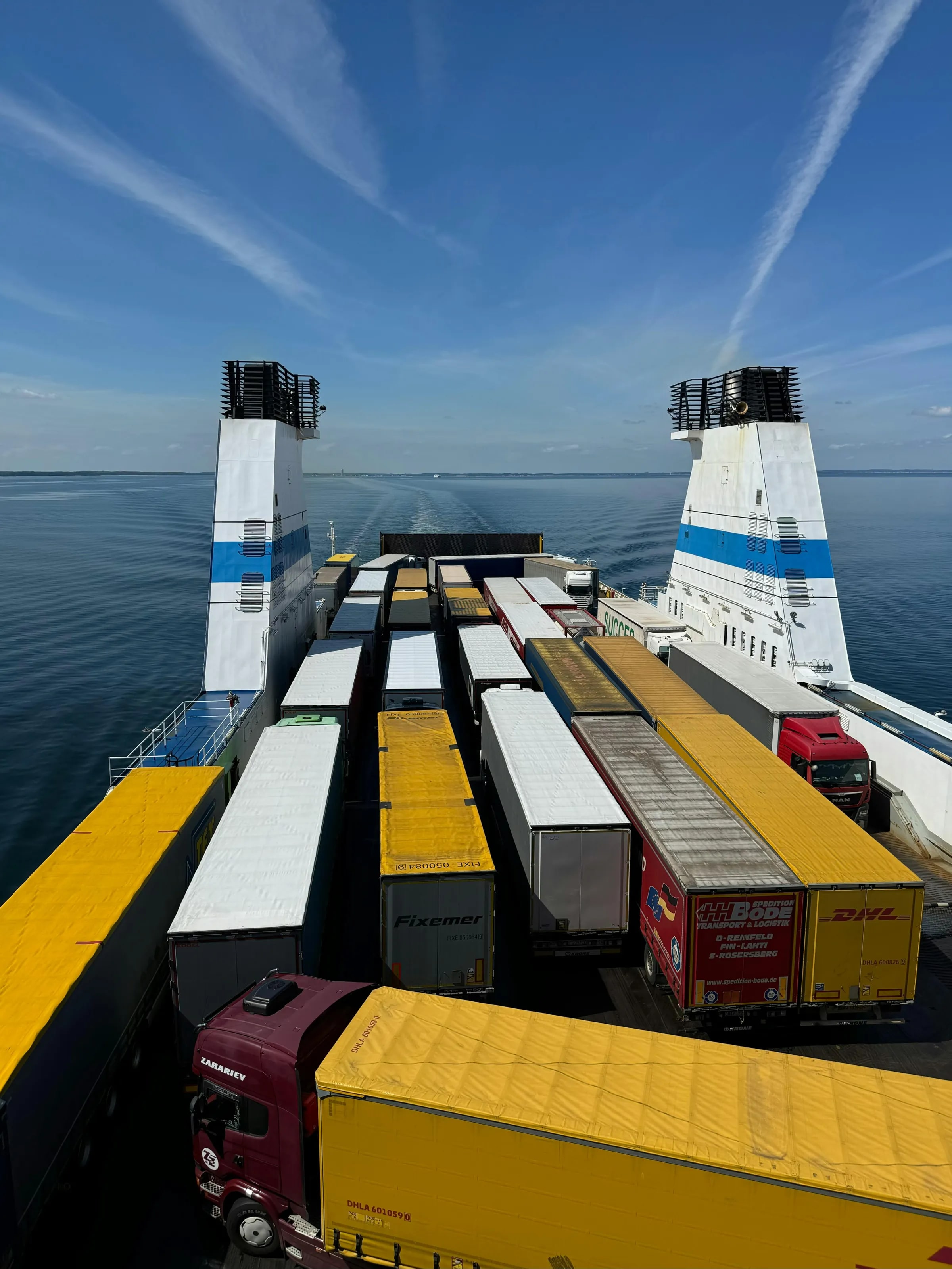 Trucks with trailers lined up on the deck of a ferry at sea
