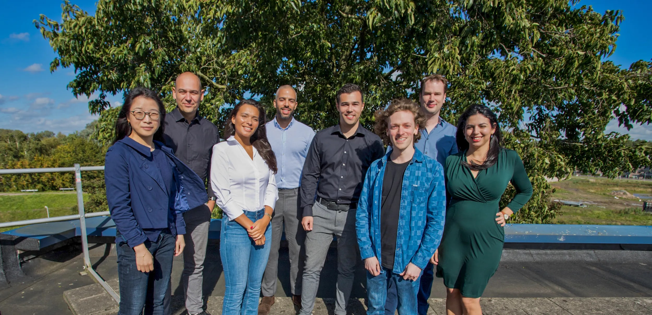 A team posing outdoors for a group photograph