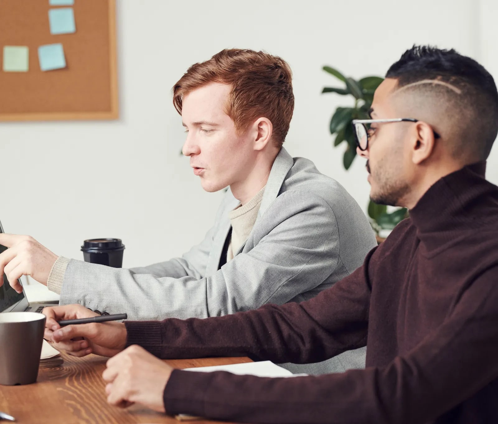 Two colleagues discussing a software solution at a table