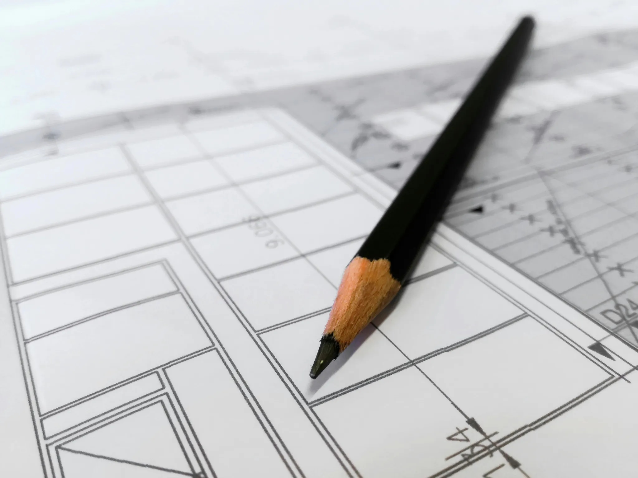 A pencil lying on a technical construction drawing