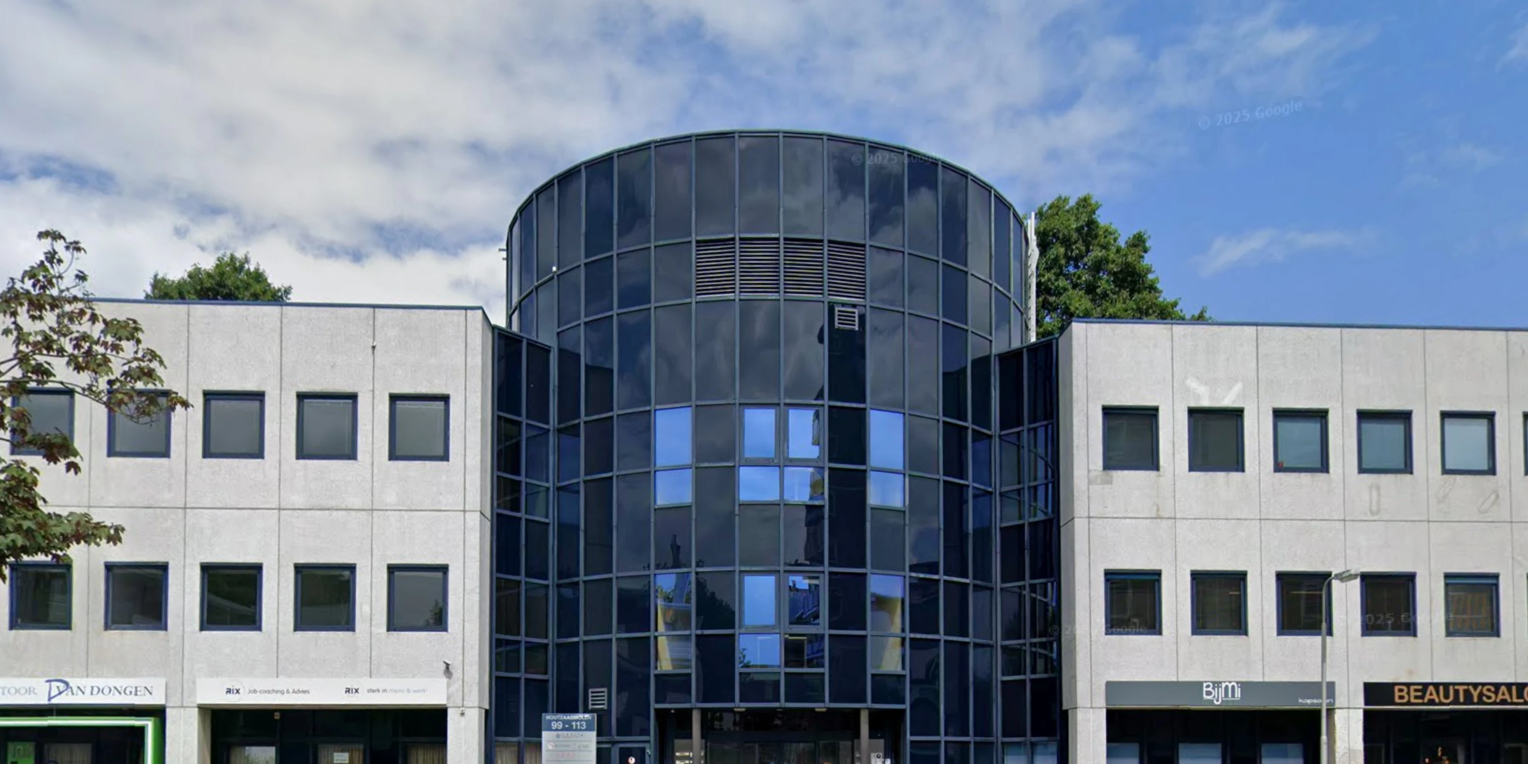 The facade of an office building on a street